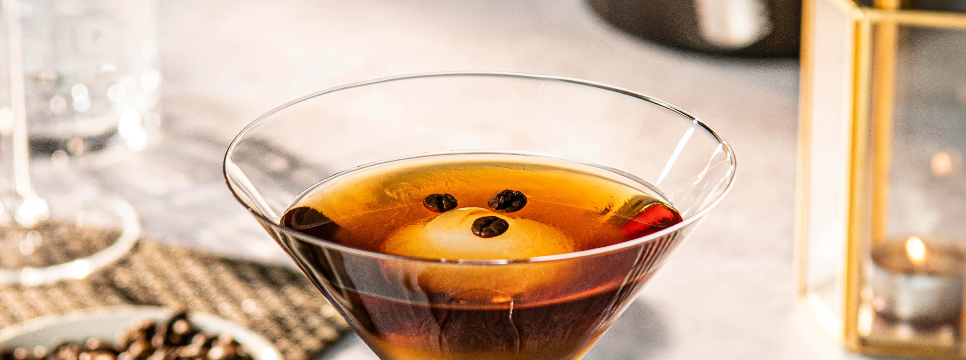 detail of martini glass with a coffee cocktail inside with coffee beans